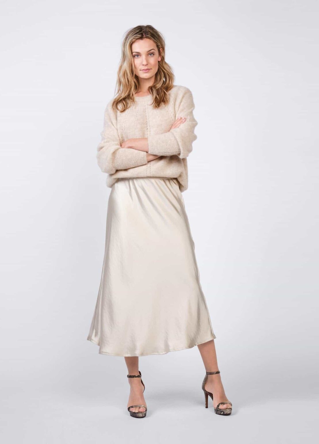 Satin skirt and cream sweater for festive brunch